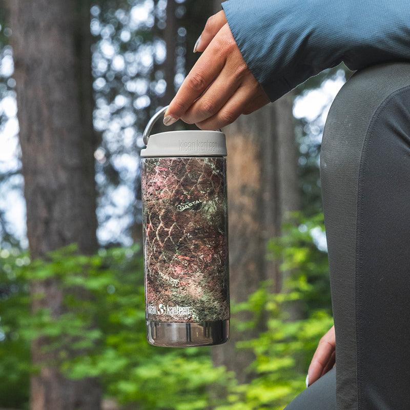 12oz-tkwide-with-cafe-cap-mossy-oak-z4 12oz_tumbler_mossyoak_rainbowtrout_hand_closeup_square.jpg