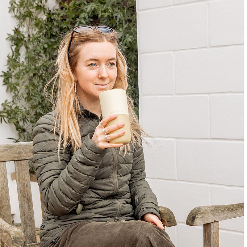 16oz-rise-tumbler-k6 16oz_rise_tumbler_wax_yellow_woman_seat_outside_square.jpg