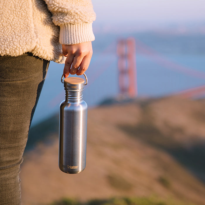 27oz-reflect-with-bamboo-cap-n9 K27SSLRF-BS-BAMBOO_reflect_bottle_bridge_lifestyle.jpg